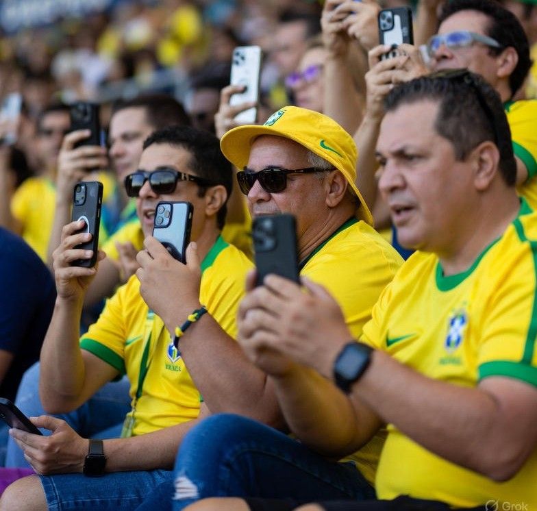 Brazilian football fans using smartphones during a match